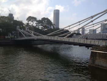 View of bridge over city against cloudy sky