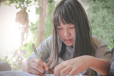 Portrait of a teenage girl sitting outdoors