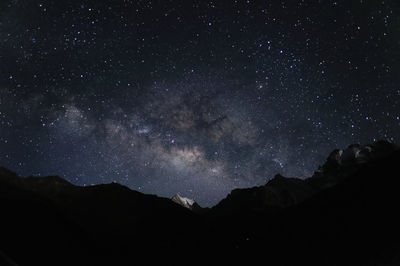 Scenic view of mountains against star field at night