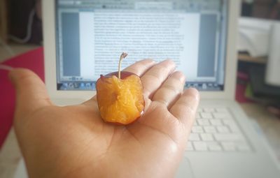 Close-up of hand holding ice cream