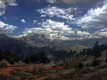 Scenic view of mountains against cloudy sky