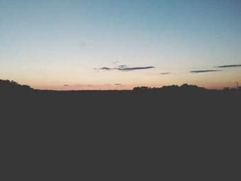 Silhouette landscape against clear sky during sunset