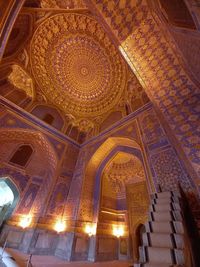 Low angle view of illuminated ceiling in historic building