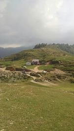 Scenic view of landscape against cloudy sky