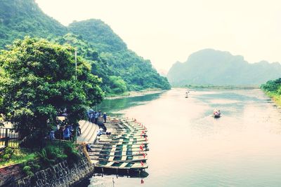 Scenic view of river and mountains against clear sky