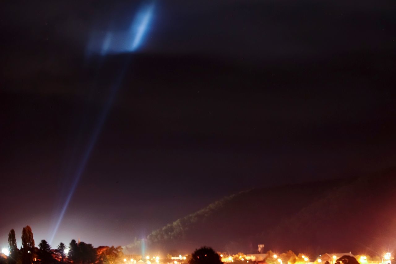 LOW ANGLE VIEW OF ILLUMINATED LIGHTS AT NIGHT