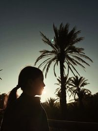 Low angle view of silhouette girl against sky during sunset