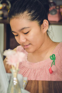 Close-up portrait of a young woman holding ice cream