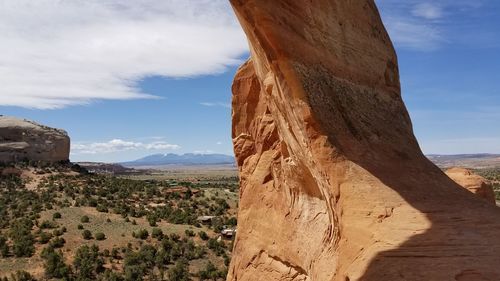 View of rock formation against cloudy sky