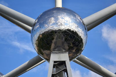 Low angle view of metallic structure against blue sky