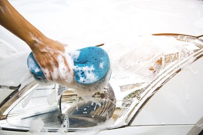 Close-up of hand by car