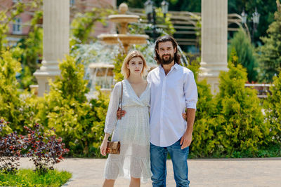 Portrait of smiling couple standing outdoors