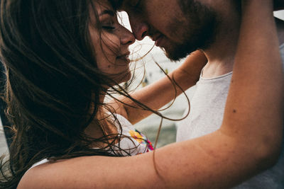 Close-up portrait of young woman holding hands