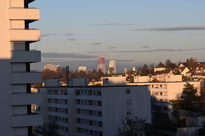 Buildings in city against sky during sunset