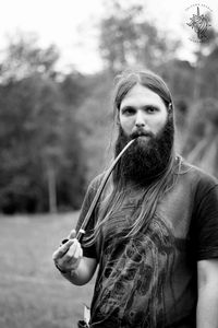 Portrait of bearded man smoking with pipe