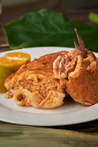 Close-up of meat and bread in plate on table