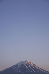 Low angle view of mountain against clear blue sky