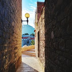 Street amidst buildings against sky