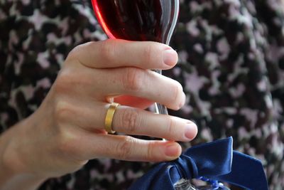 Close-up of woman hand holding wineglass