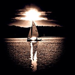 Boats in calm sea at sunset