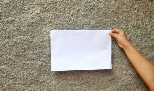 Low section of person holding paper