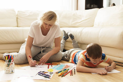 Mother and daughter on bed at home