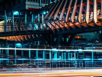 Illuminated light trails on road in city at night