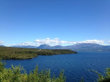 Scenic view of mountains against blue sky