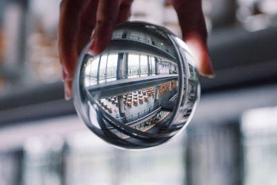 Close-up of hand holding crystal ball