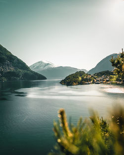 Scenic view of sea and mountains against clear sky