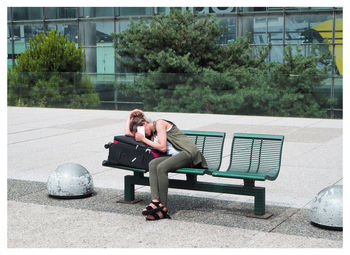 Man sitting on bench in park