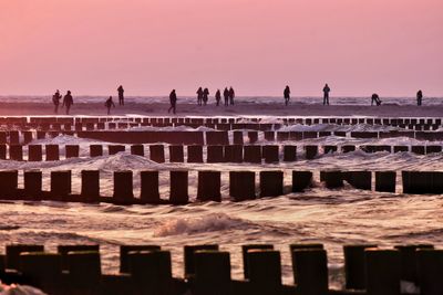 People at beach during sunset