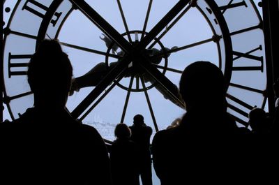 Low angle view of silhouette people against clear sky