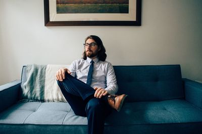 Portrait of a man sitting on sofa