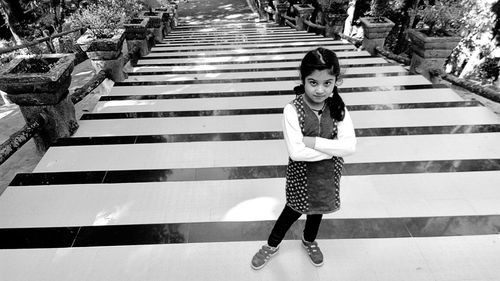 High angle view of cute girl standing on steps