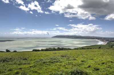 Scenic view of sea and landscape against sky