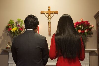 Rear view of couple standing at altar in church during engagement