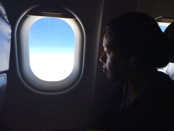 Woman looking through airplane
