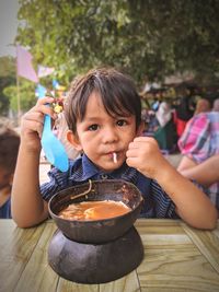 Portrait of a boy holding ice cream