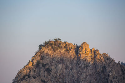 Low angle view of rock formation against clear sky