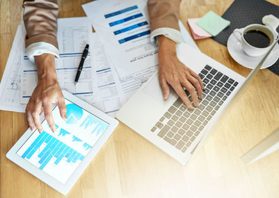 Midsection of business colleagues working on table