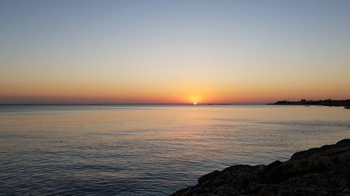 Scenic view of sea against clear sky during sunset