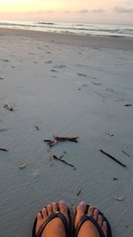 Low section of person standing on beach