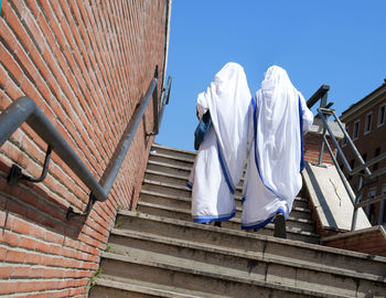 Low angle view of clothes drying against building