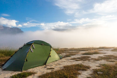 Tent on field against sky