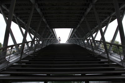 Low angle view of footbridge against sky