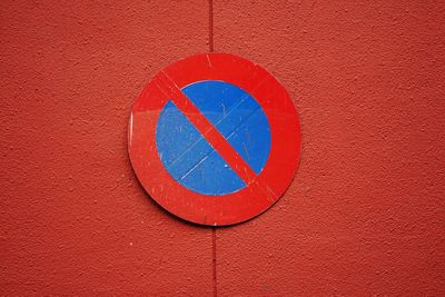 Close-up of arrow sign on wall