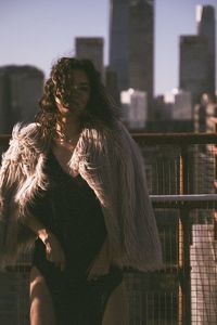 Midsection of woman standing by city