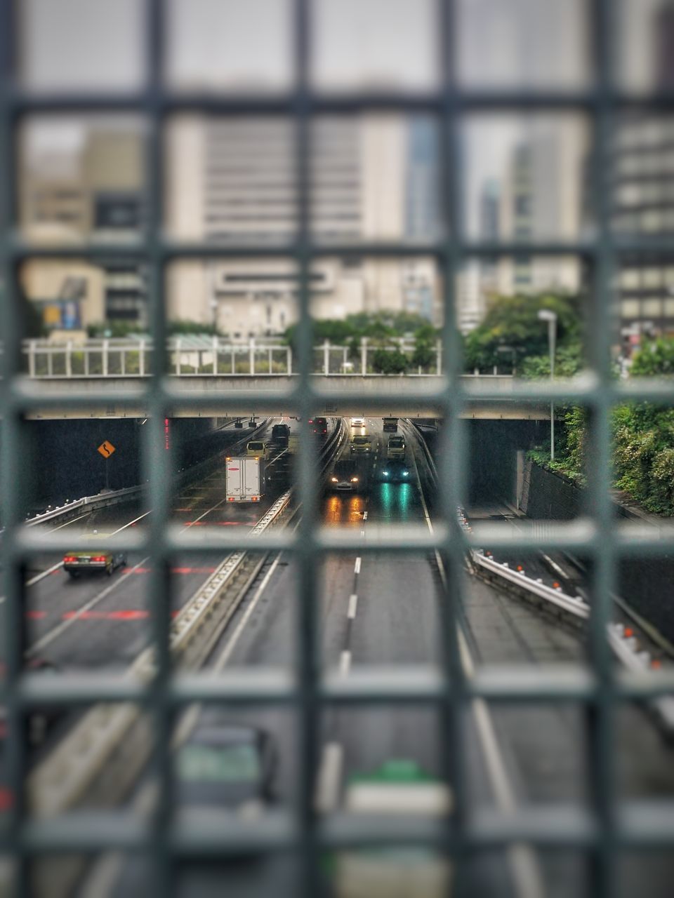 architecture, selective focus, built structure, city, transportation, no people, mode of transportation, rail transportation, building exterior, train, public transportation, metal, railroad track, outdoors, track, train - vehicle, high angle view, building, window, railing, cityscape