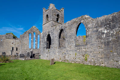 Old ruins of building against blue sky